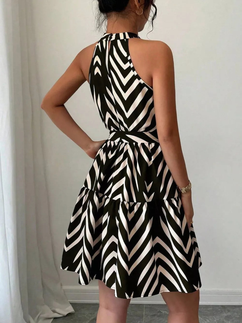Black halter neck tie-waist ruffle dress with chevron pattern