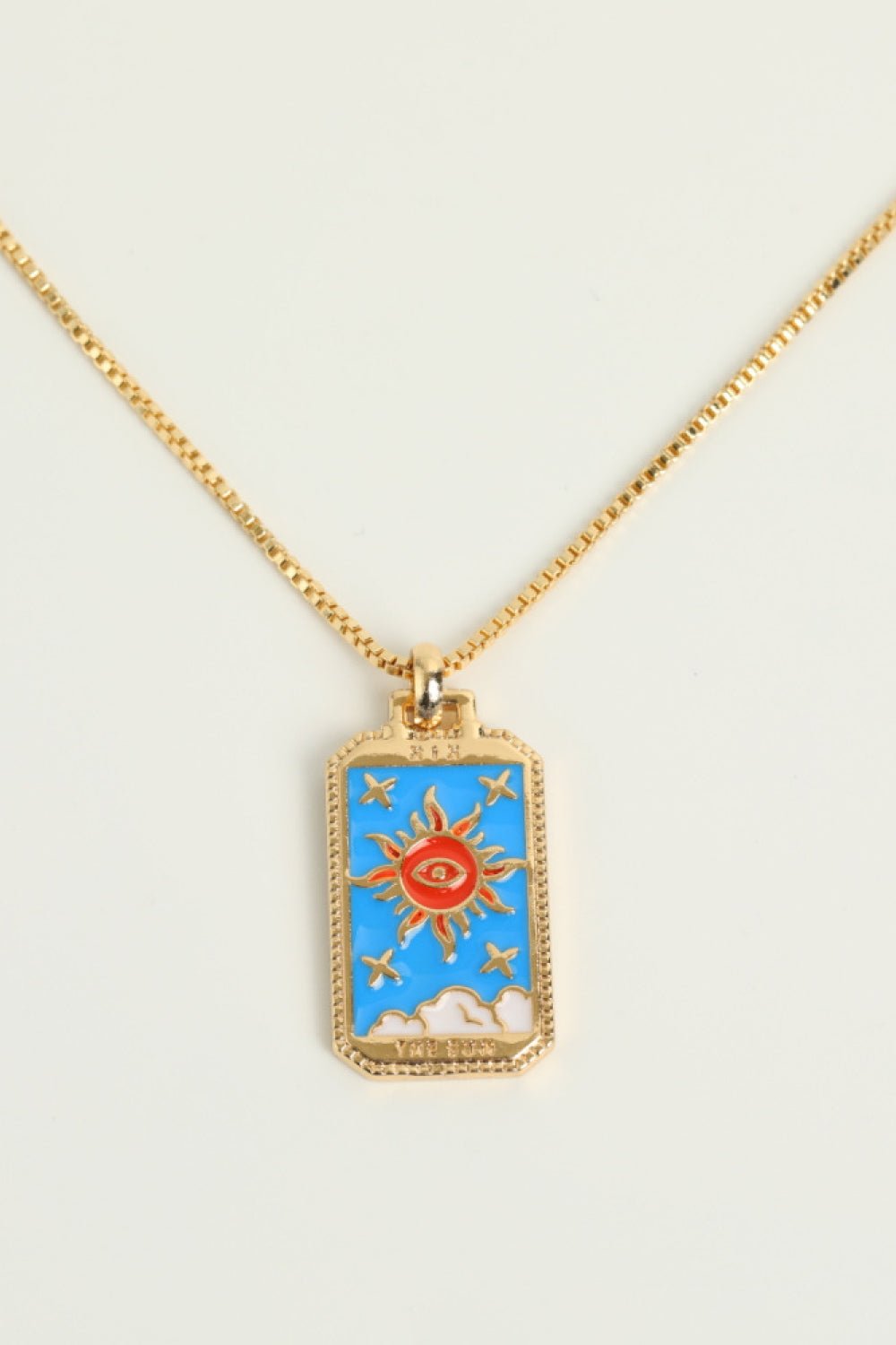 Celestial tarot pendant necklace in Sun color with gold chain and sun eye design