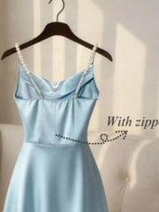 Light blue cowl neck maxi dress with pearl straps and zipper detail.