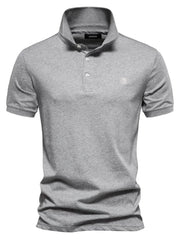 Gray cotton polo shirt with embroidered crest detail and button placket.