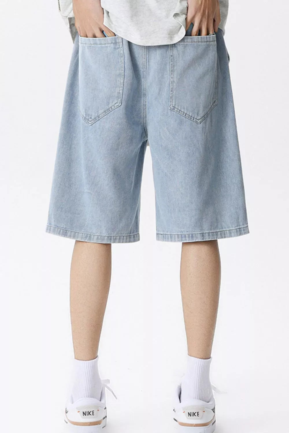 Light blue denim shorts for men with vintage wash and drawstring waist.