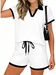 White polo collar two-piece set with black trim, drawstring shorts with pockets.