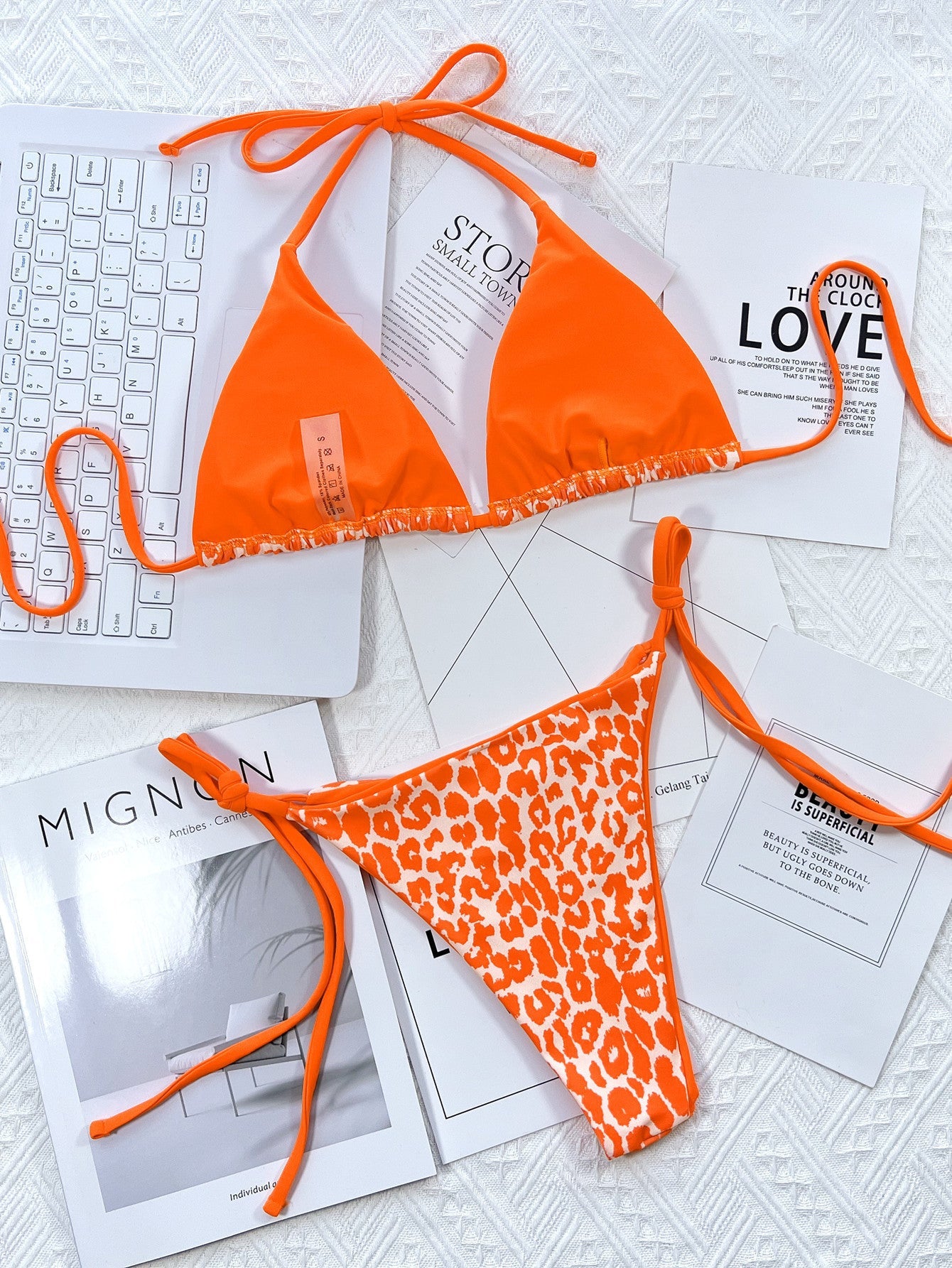 Tangerine bikini set with leopard print bottoms and tie sides.