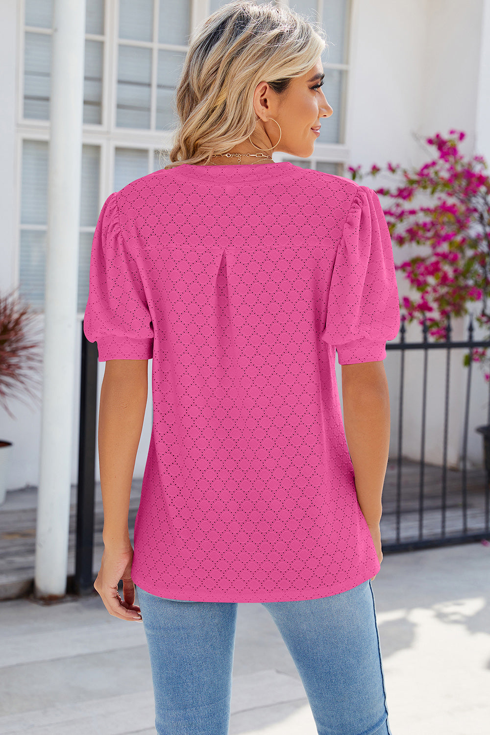 Hot Pink eyelet V-neck blouse with puff sleeves and a relaxed fit.