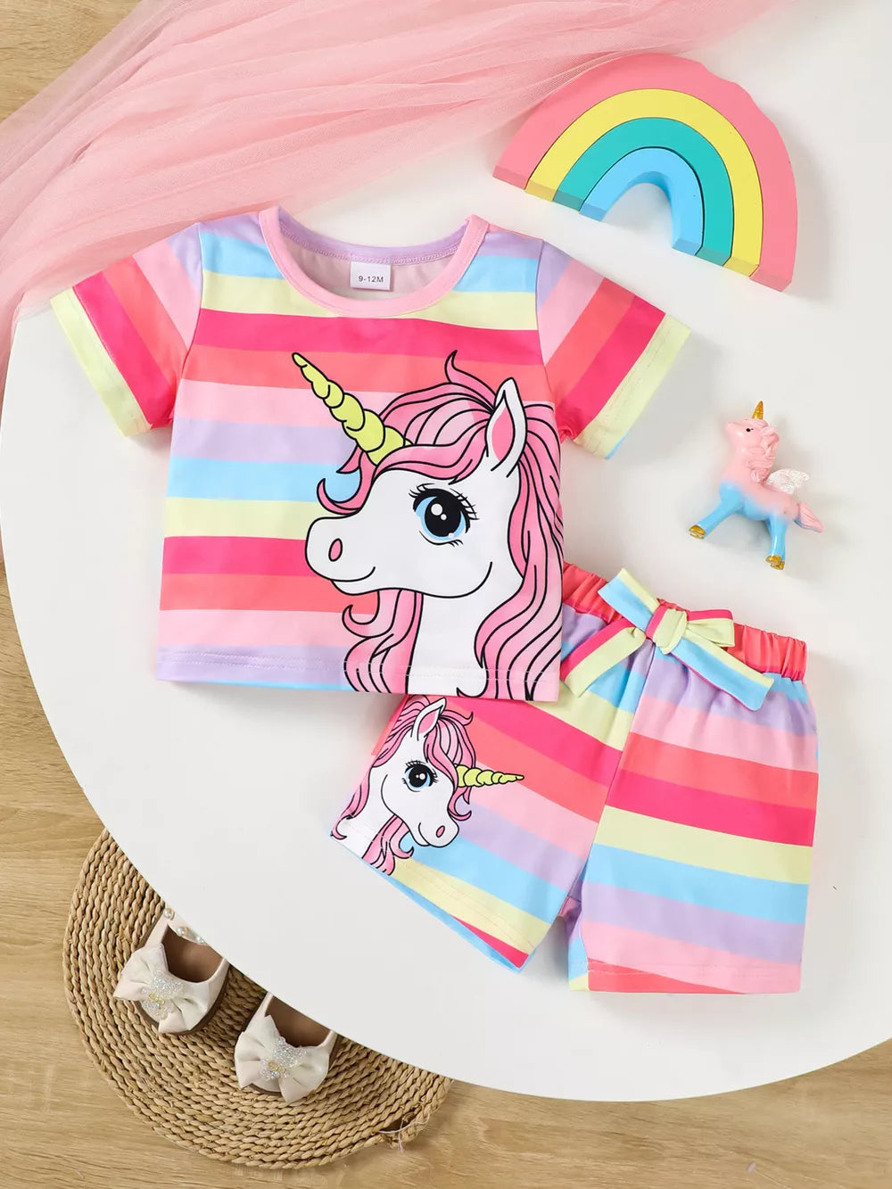 Baby girls unicorn rainbow striped shorts set with unicorn graphic.