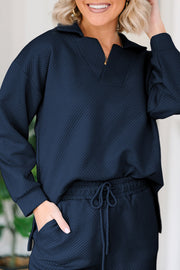 Navy textured polo top with quarter zip and wide-leg culottes with drawstring waist.