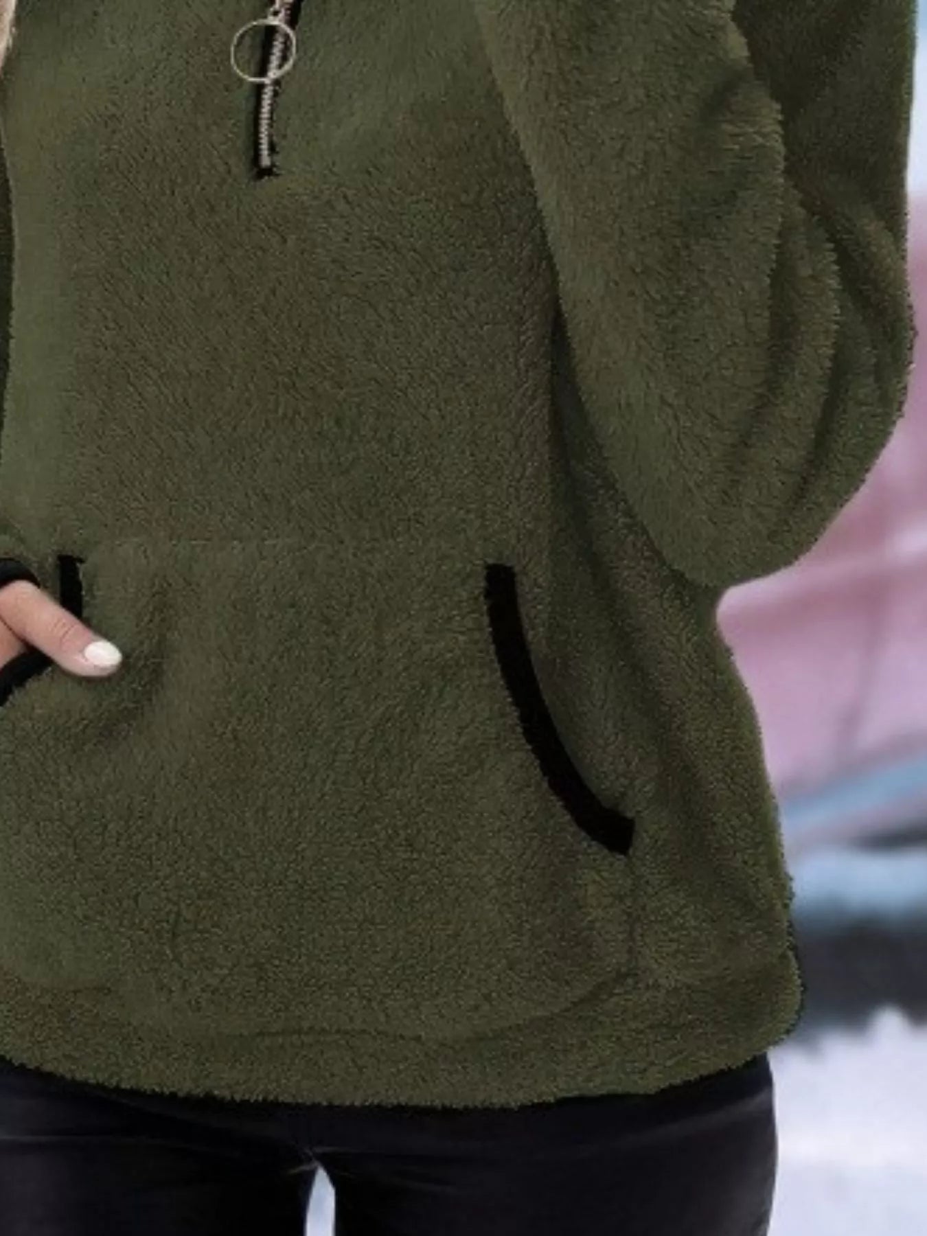 Army green fleece quarter zip pullover with black trim pocket and zipper detail.