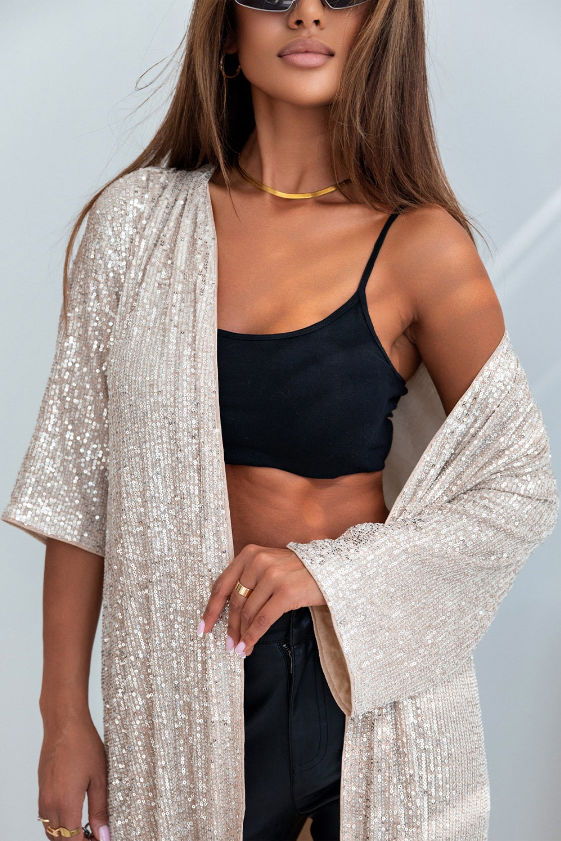 Beige sequin kimono jacket with wide sleeves, worn open over a black camisole.