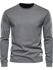 Gray crewneck long sleeve t-shirt with a small woven label detail on the hem.