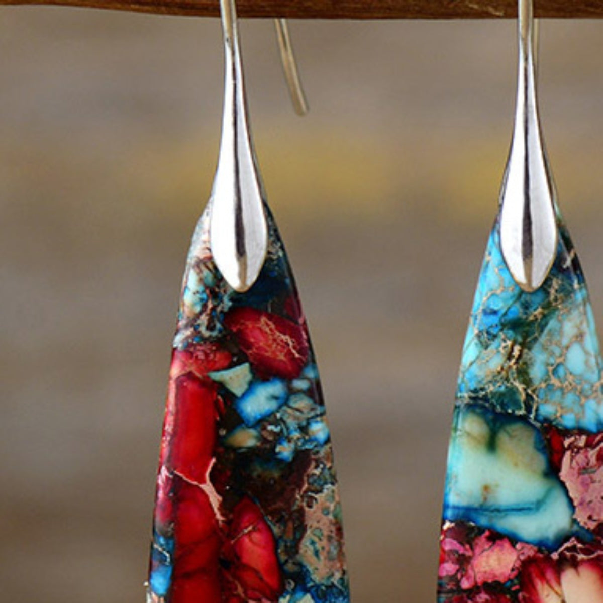 Marbled stone teardrop earrings in red/gold and red/silver feature unique patterns and silver accents.