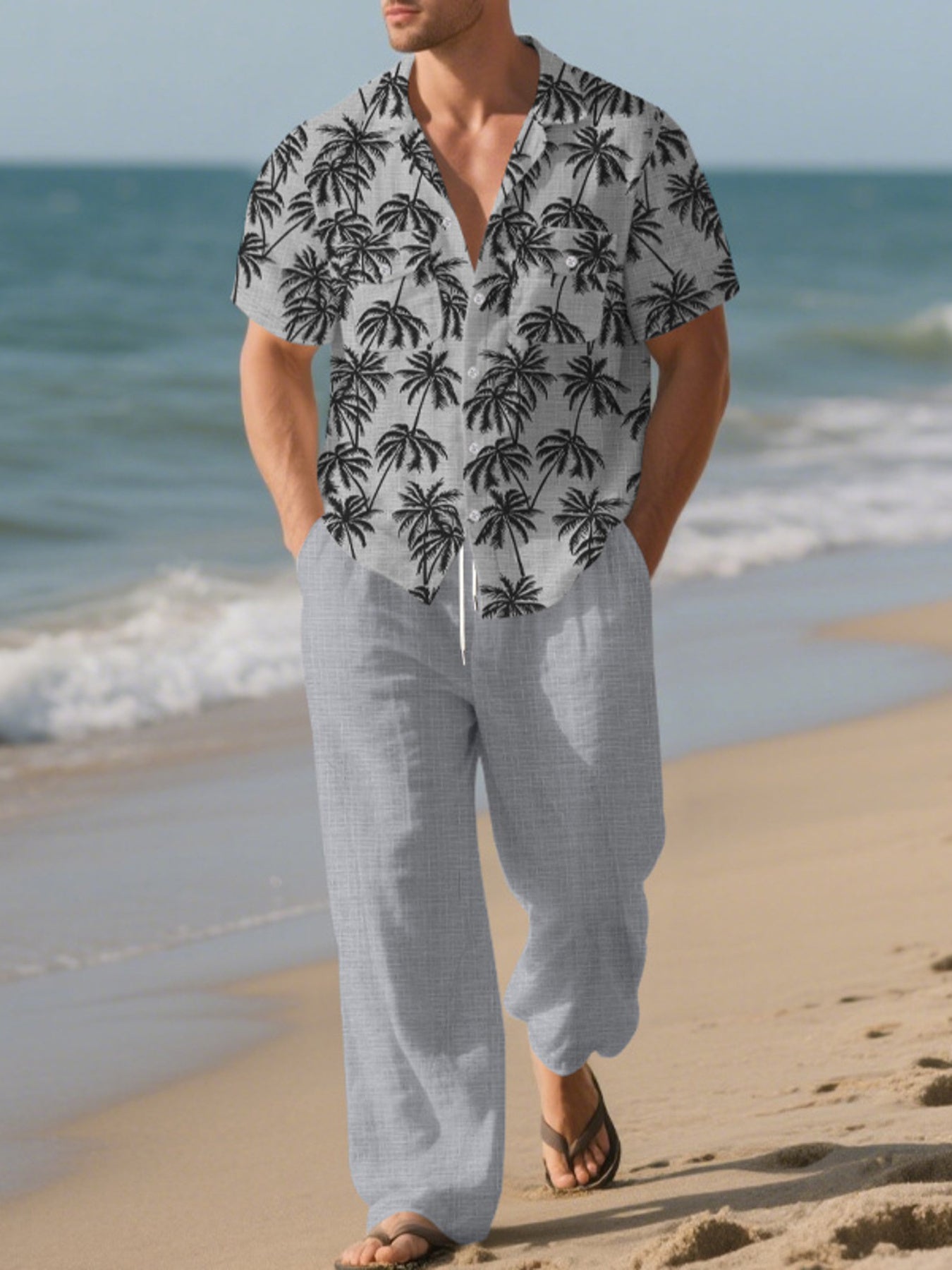Men's gray palm print relaxed fit pants with drawstring waist, paired with a matching short-sleeve button-down shirt.