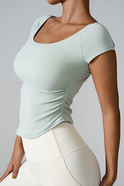 Light Green performance tee with gathered side detail and scoop neck.