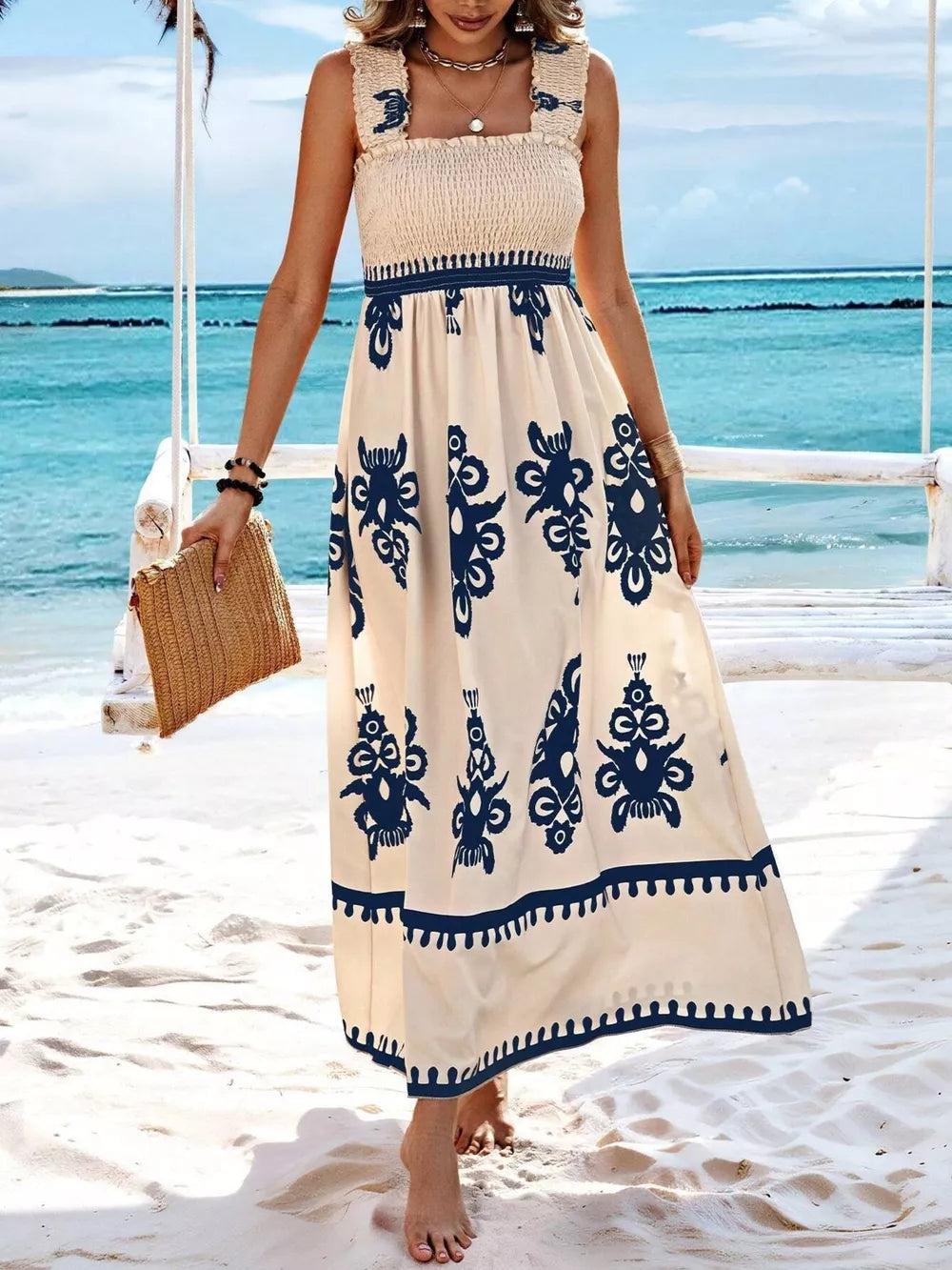 Maxi dress with smocked bodice, square neck, and navy blue print on cream.