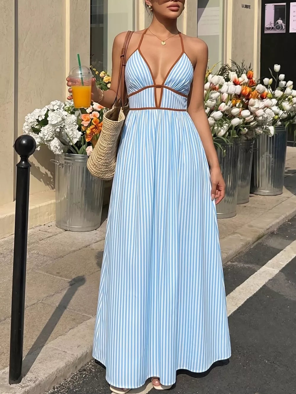 Blue striped halter maxi dress with brown trim and a-line skirt.