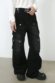 Oversized dark denim cargo pants with multiple buttoned pockets and a wide leg.