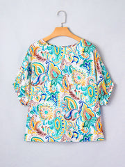 Paisley floral puff sleeve blouse with a round neckline in white with blue, green, yellow, and brown print.