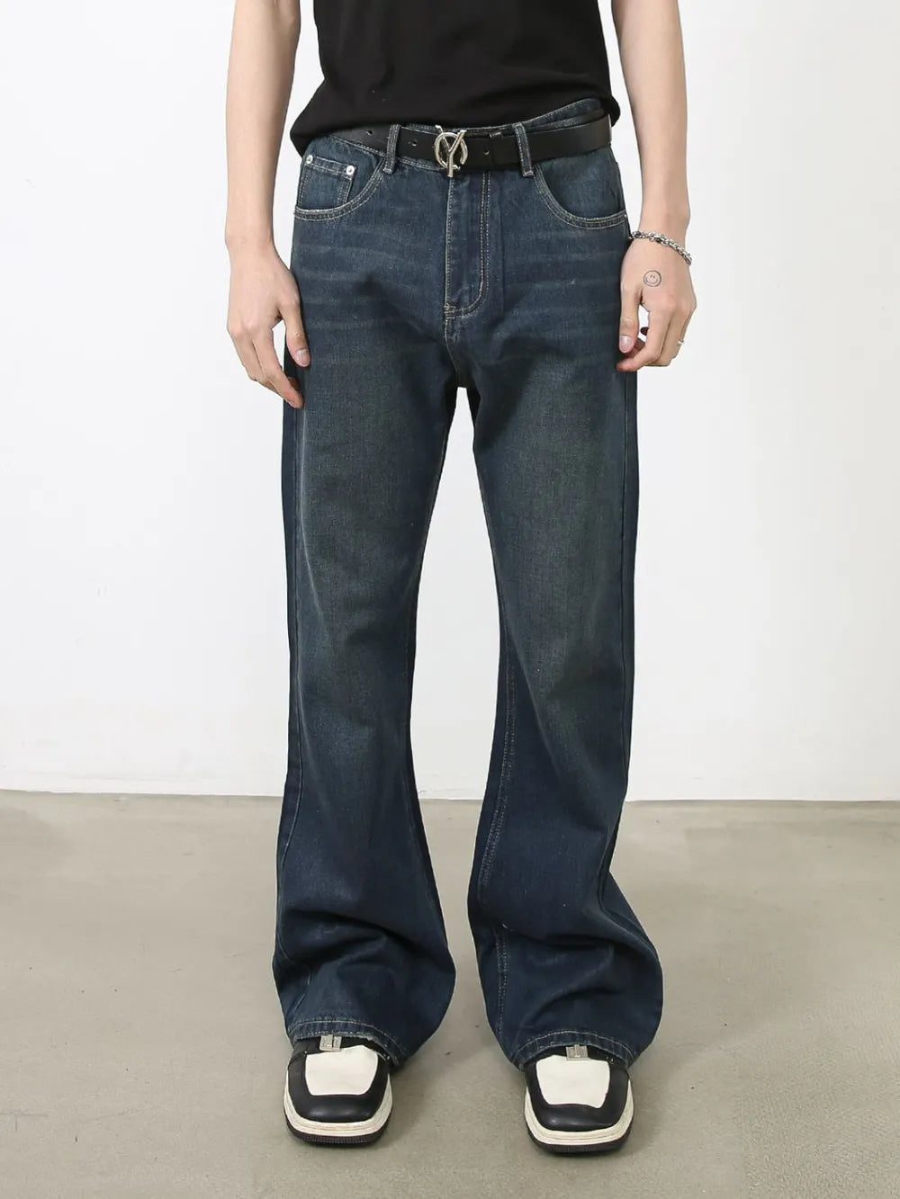 Flared dark wash denim jeans with subtle fading and bootcut leg