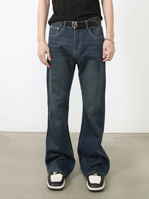 Flared dark wash denim jeans with subtle fading and bootcut leg