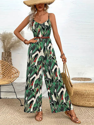 Botanical print cami jumpsuit in dark green with wide legs and a braided belt.