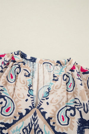 Paisley print blouse in ivory with a V-neck and slit sleeves.