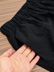 Black relaxed fit wide-leg pants with elastic waistband and side pocket detail.