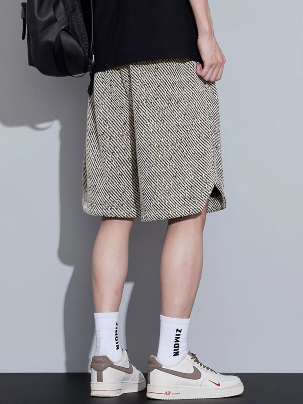 Men's boxer shorts with a black and beige abstract stripe pattern and adjustable drawstring.