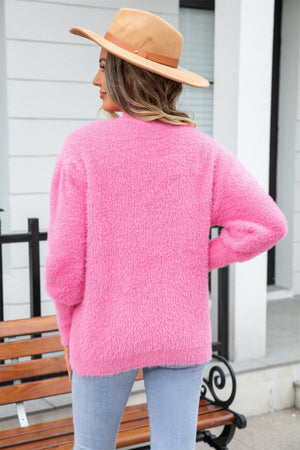Fluffy pink acrylic mock neck sweater with long sleeves.
