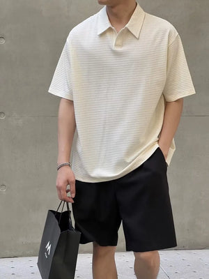 Men's eggshell waffle knit polo shirt with button collar and short sleeves.