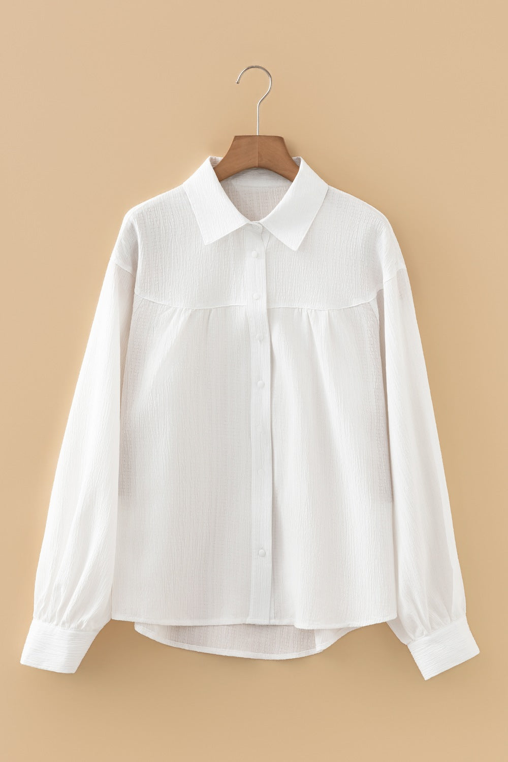 White crinkled texture button-down shirt with classic collar and lantern sleeves.