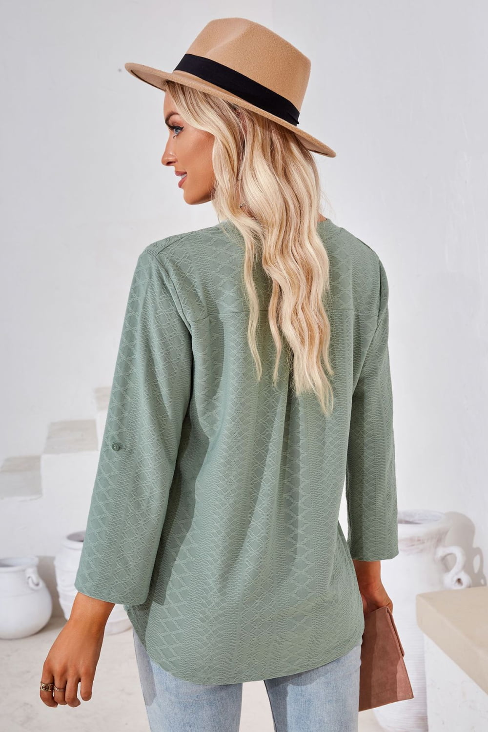 Sage textured henley blouse with rolled sleeves and a relaxed fit.