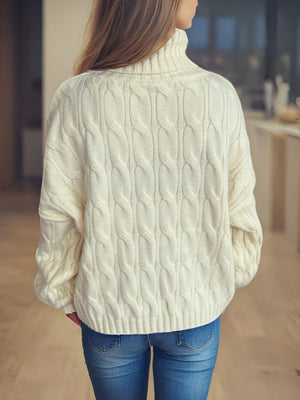 Ivory oversized cable knit turtleneck sweater with ribbed cuffs and hem.