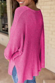 Hot Pink waffle knit V-neck sweater with slit hem and long sleeves.
