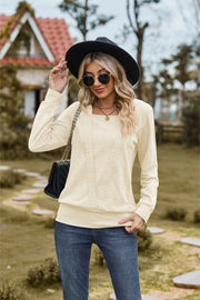 Textured knit sweater in ivory with a square neckline and long sleeves.