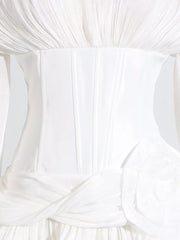 White ruffle mini dress with balloon sleeves, corset bodice, and floral detail.