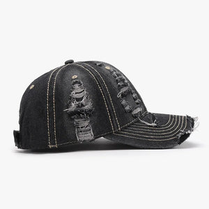 Dark ripped denim baseball cap with distressed details and contrast stitching.