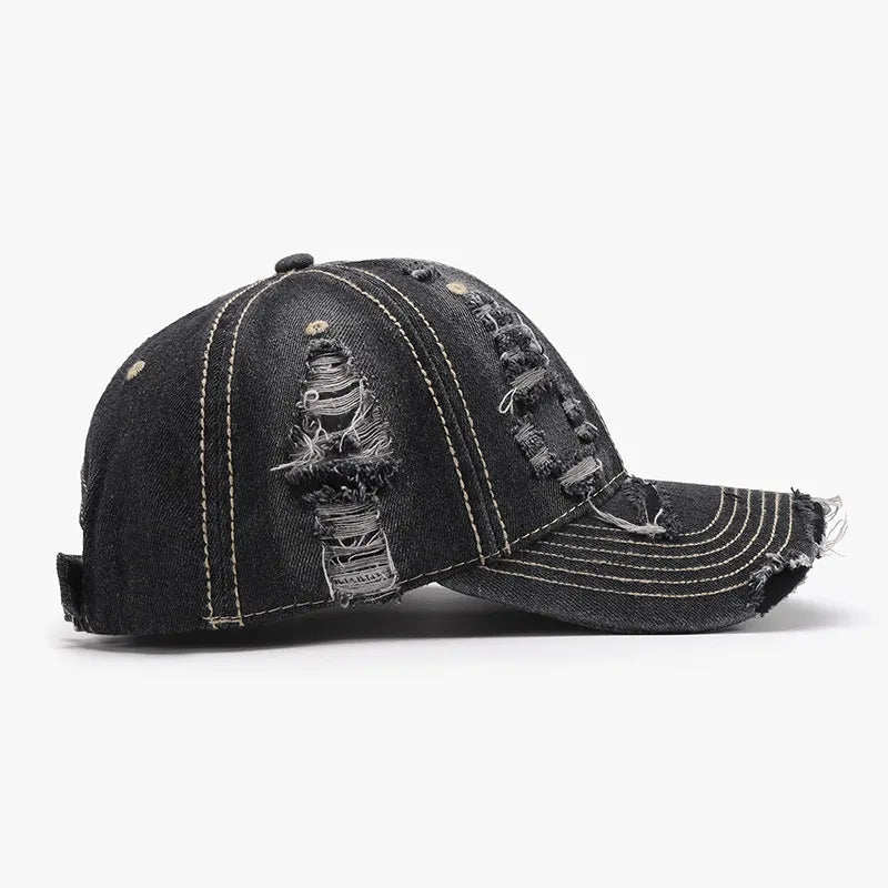 Dark ripped denim baseball cap with distressed details and contrast stitching.