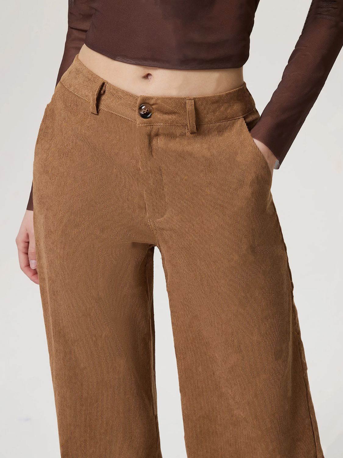 Camel corduroy wide-leg trousers with button closure and front pockets.