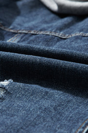 Dark blue denim jacket with a grey hooded layer detail and distressed accents.