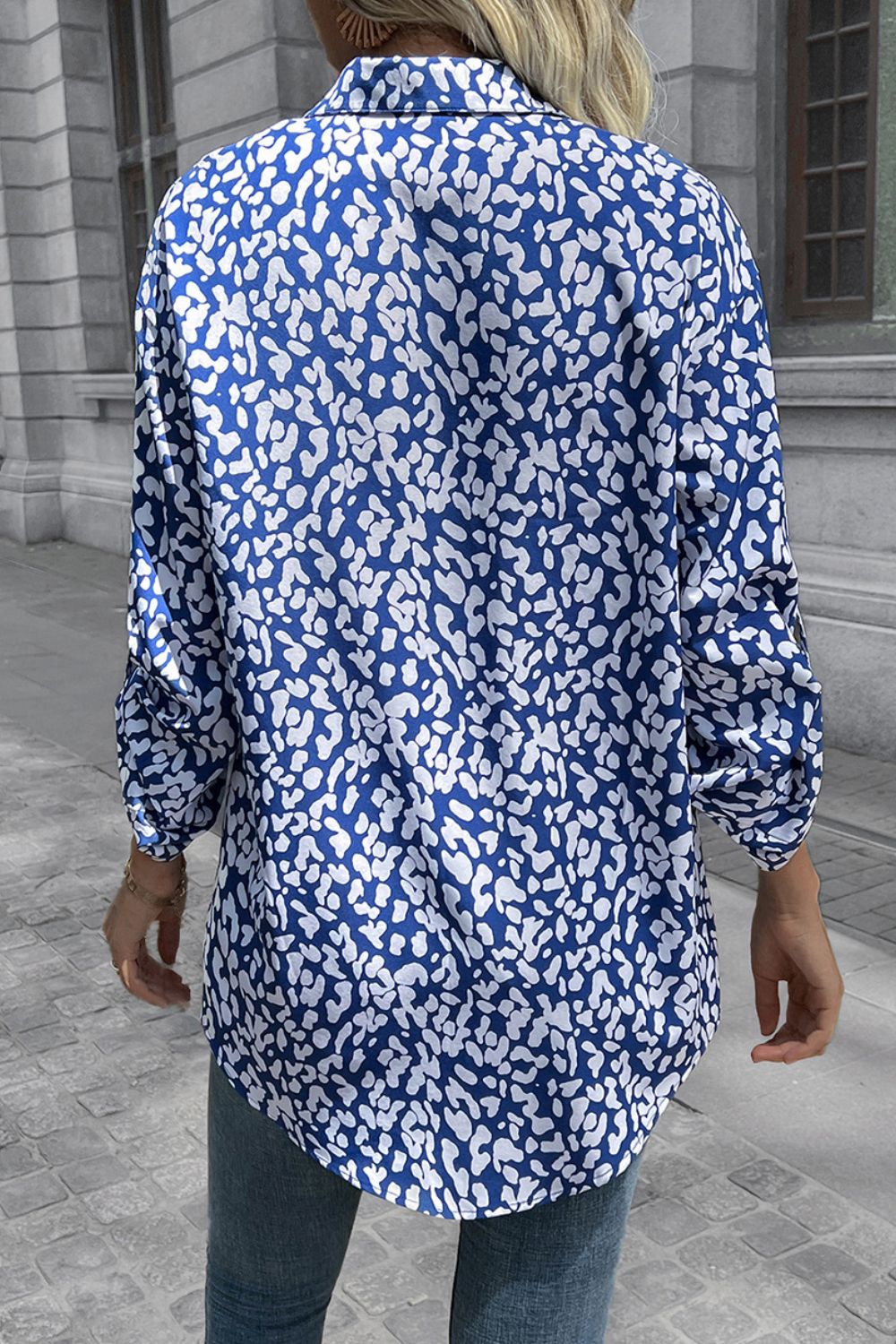 Women's sky blue oversized shirt with abstract white spot print, long sleeves, and buttoned collar.