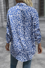Women's sky blue oversized shirt with abstract white spot print, long sleeves, and buttoned collar.