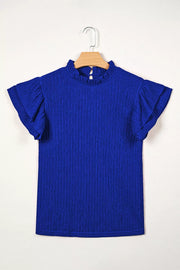 Blue textured short sleeve shirt with ruffle trim and mock neck.