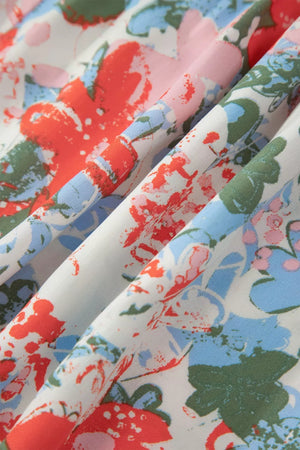 Maxi dress with abstract floral print in red, blue, pink, and green on white fabric.