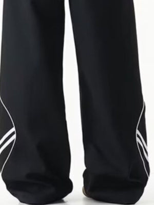 Men's black wide leg track pants with white stripe detail on the side.