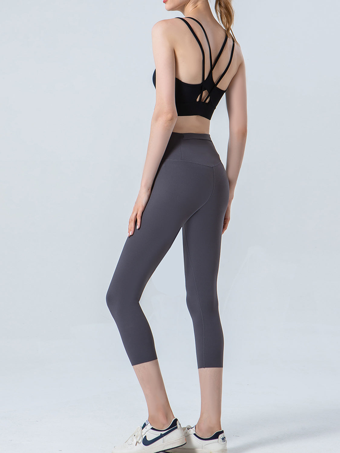 Charcoal capri leggings with a high waist and sculpted fit.