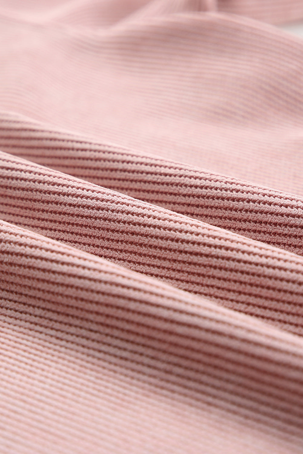 Dusty pink polyester sweatshirt with ribbed texture and XOXO appliqué detail.