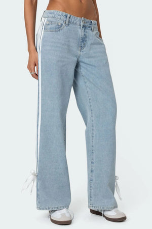Light blue denim wide-leg trousers with white side stripes and ankle ties.