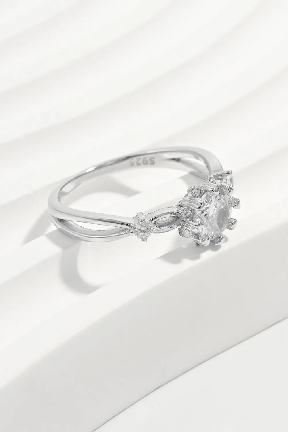 Silver halo ring with round-cut zirconia and floral accents