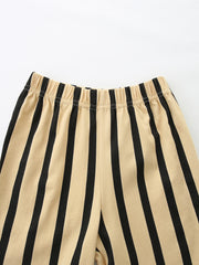 Baby shorts with beige and black vertical stripes and elastic waistband.