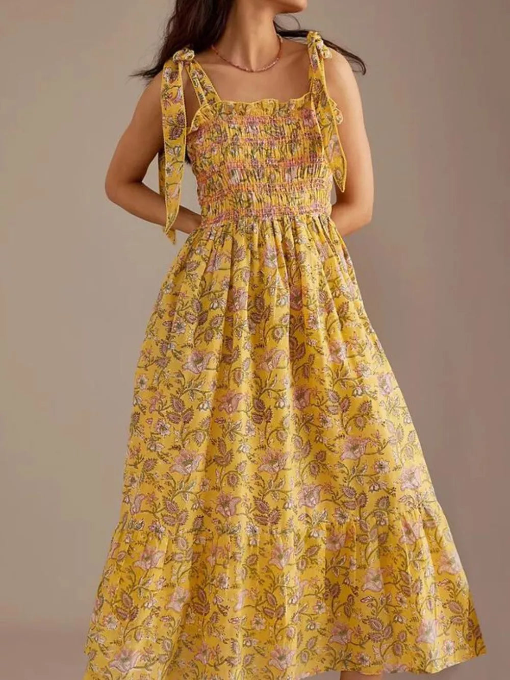 Yellow floral midi dress with smocked bodice and tie shoulders.