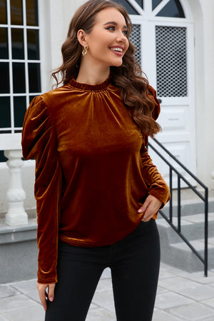 Brown velvet blouse with gathered puff sleeves and mock neck.